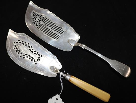 A George III ivory handled silver fish slice and an early Victorian Scottish silver fish slice, gross 7 oz.